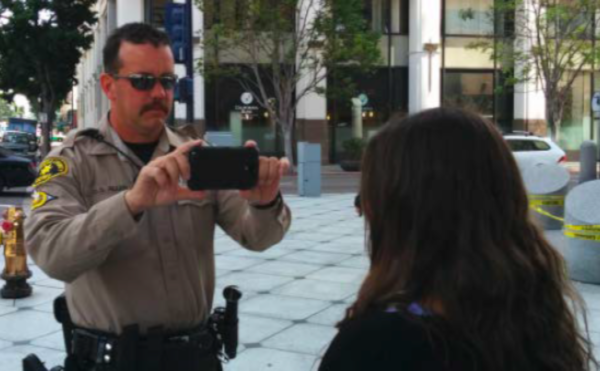 Law enforcement officer taking a photo with a mobile device