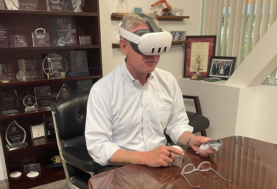 Peters’ Instagram A member of Congress sitting at a table with a white Meta Quest 2 headset strapped to his head.