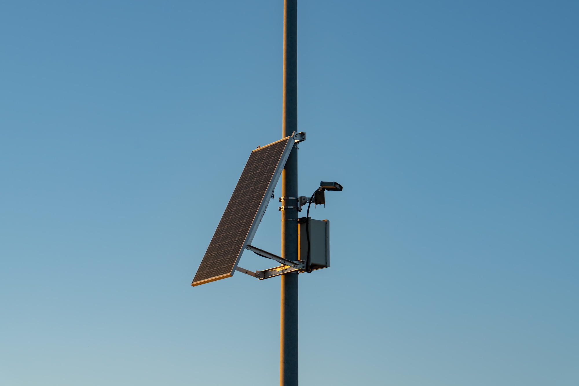 A camera and solar panel attached to a streetlight pole. A camera and solar panel attached to a streetlight pole.